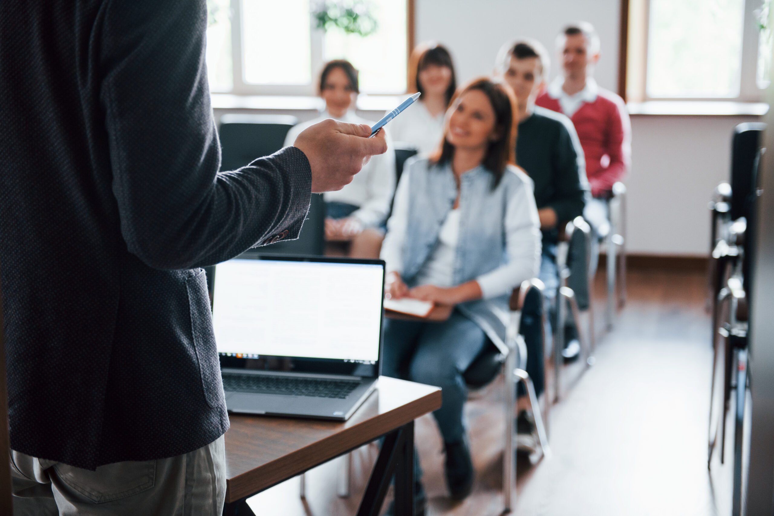 everyone is smiling listens group people business conference modern classroom daytime scaled - Techkeymonk