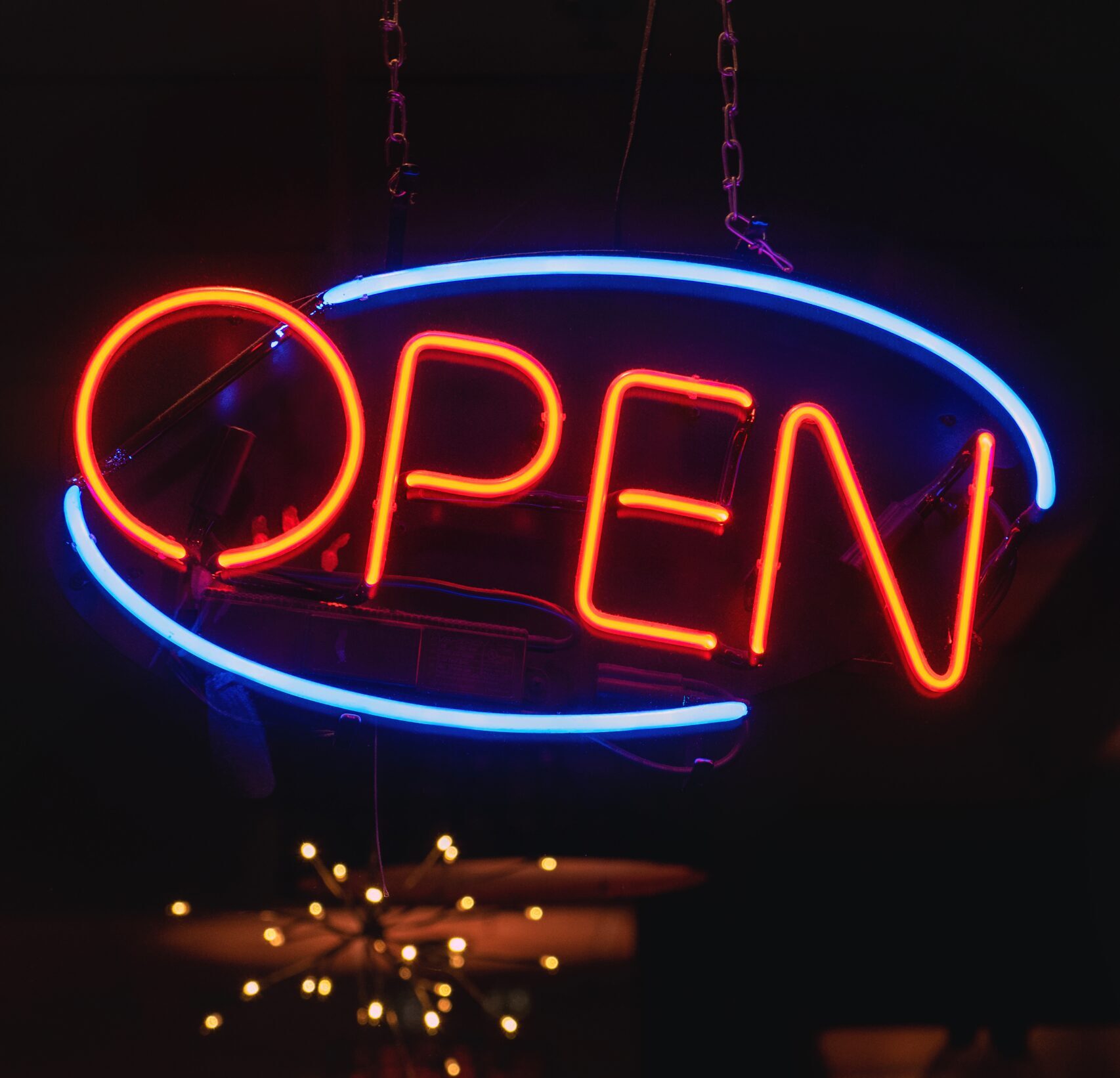 vertical shot orange blue neon sign that says open bar scaled e1727158019751 - Techkeymonk