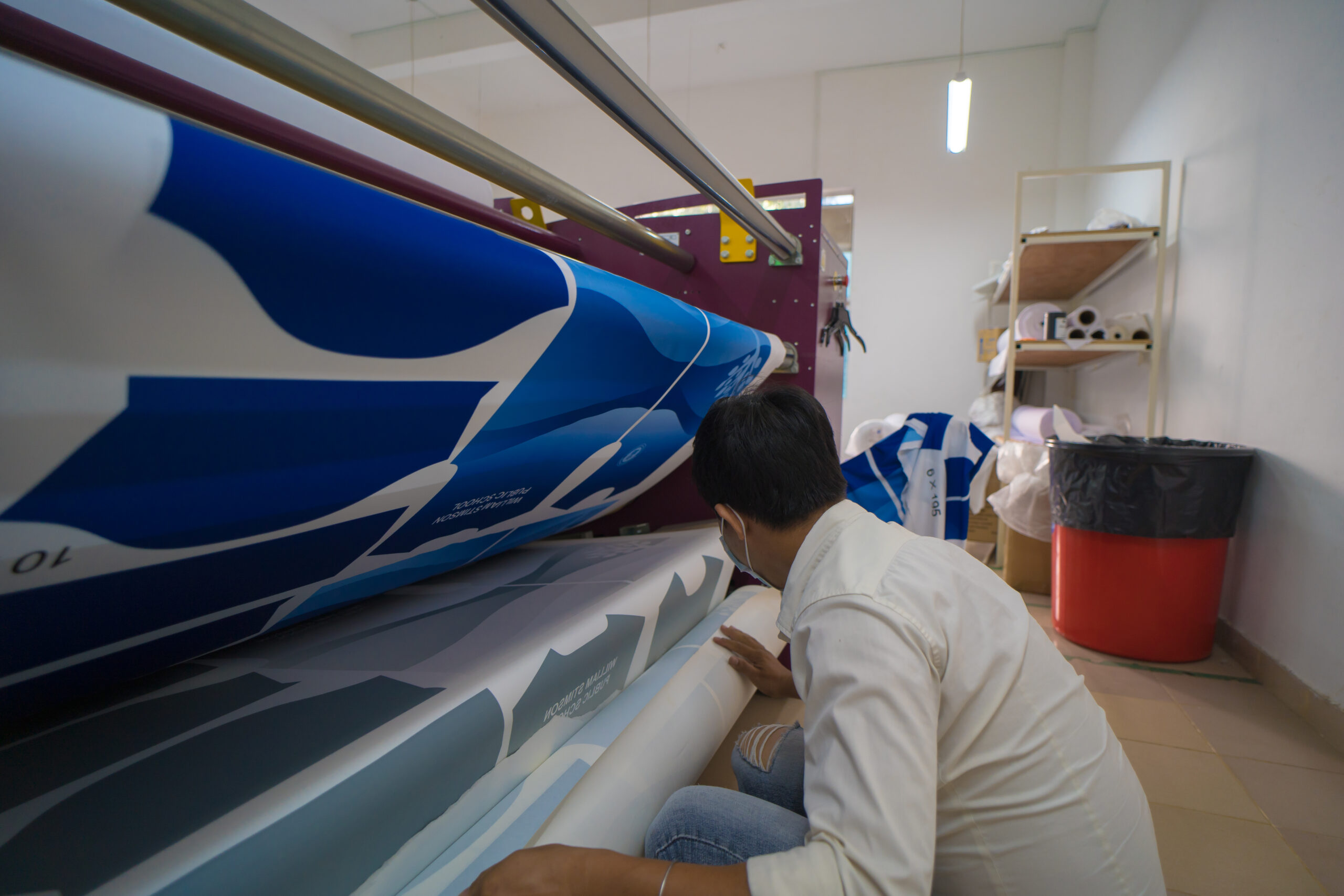 young asian male worker technician wearing medical mask make object sublimation heat press scaled - Techkeymonk